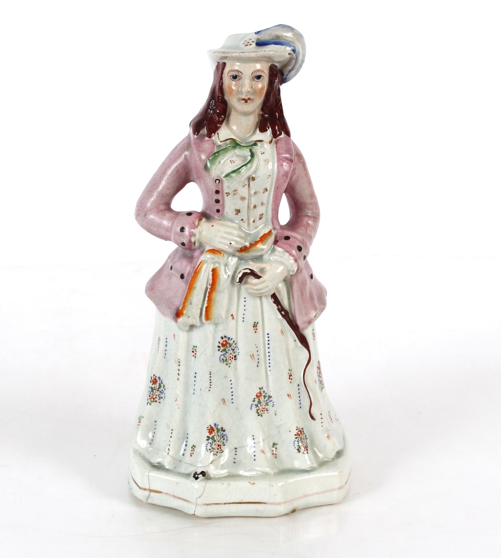 A Staffordshire cow and calf spill holder AF; a Staffordshire figure of a maiden with riding whip;