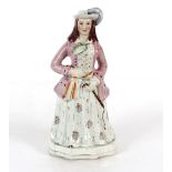 A Staffordshire cow and calf spill holder AF; a Staffordshire figure of a maiden with riding whip;