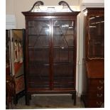 A 19th Century mahogany Chippendale design display cabinet, surmounted by a scrolled pierced