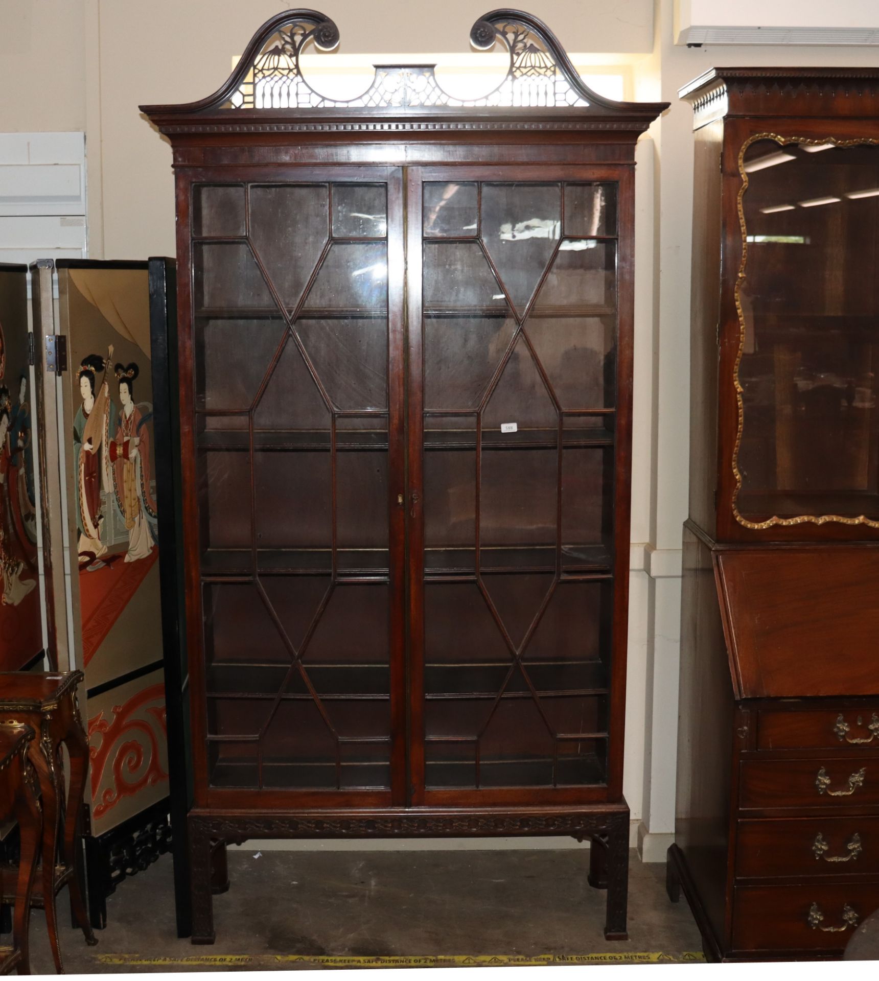 A 19th Century mahogany Chippendale design display cabinet, surmounted by a scrolled pierced