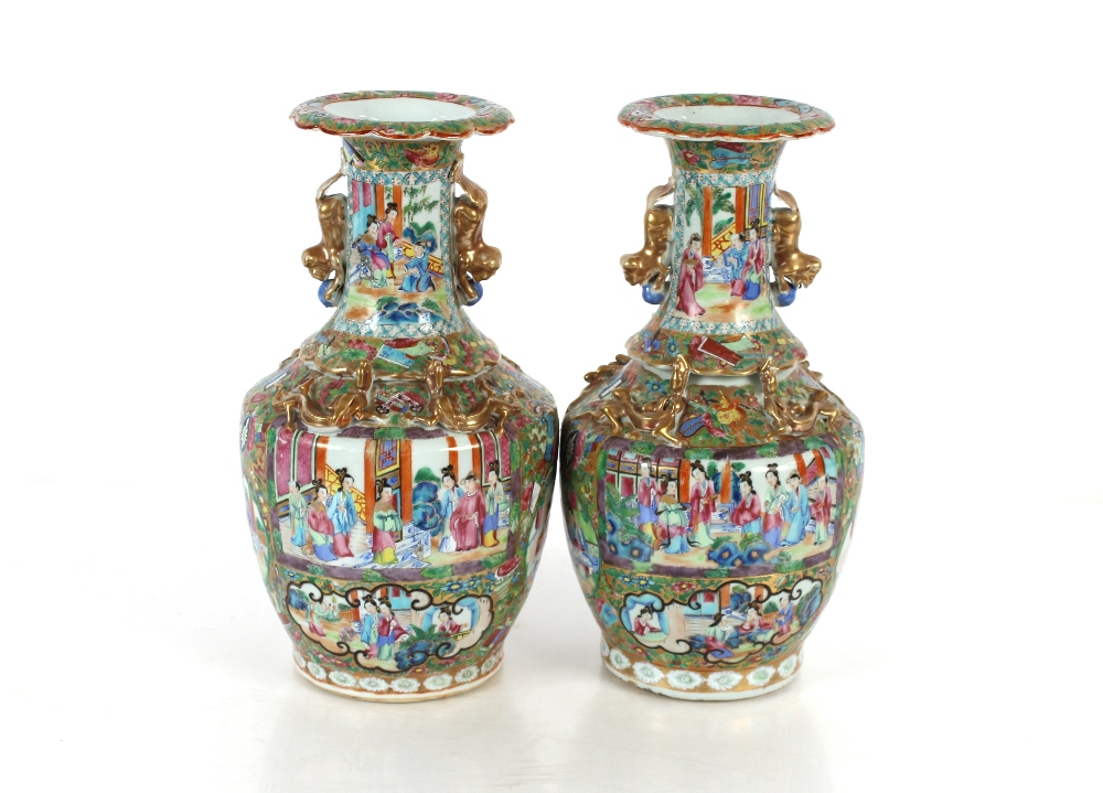 A pair of 19th Century Chinese Canton baluster vases, decorated in the traditional manner with