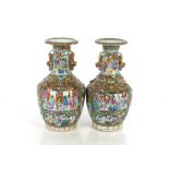 A pair of 19th Century Chinese Canton baluster vases, decorated in the traditional manner with