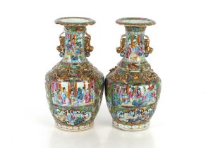 A pair of 19th Century Chinese Canton baluster vases, decorated in the traditional manner with