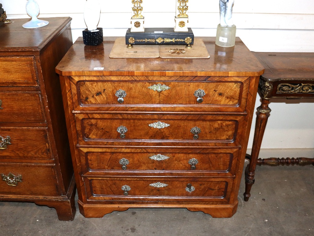 A 19th Century continental walnut chest, fitted four long graduated drawers with brass foliate