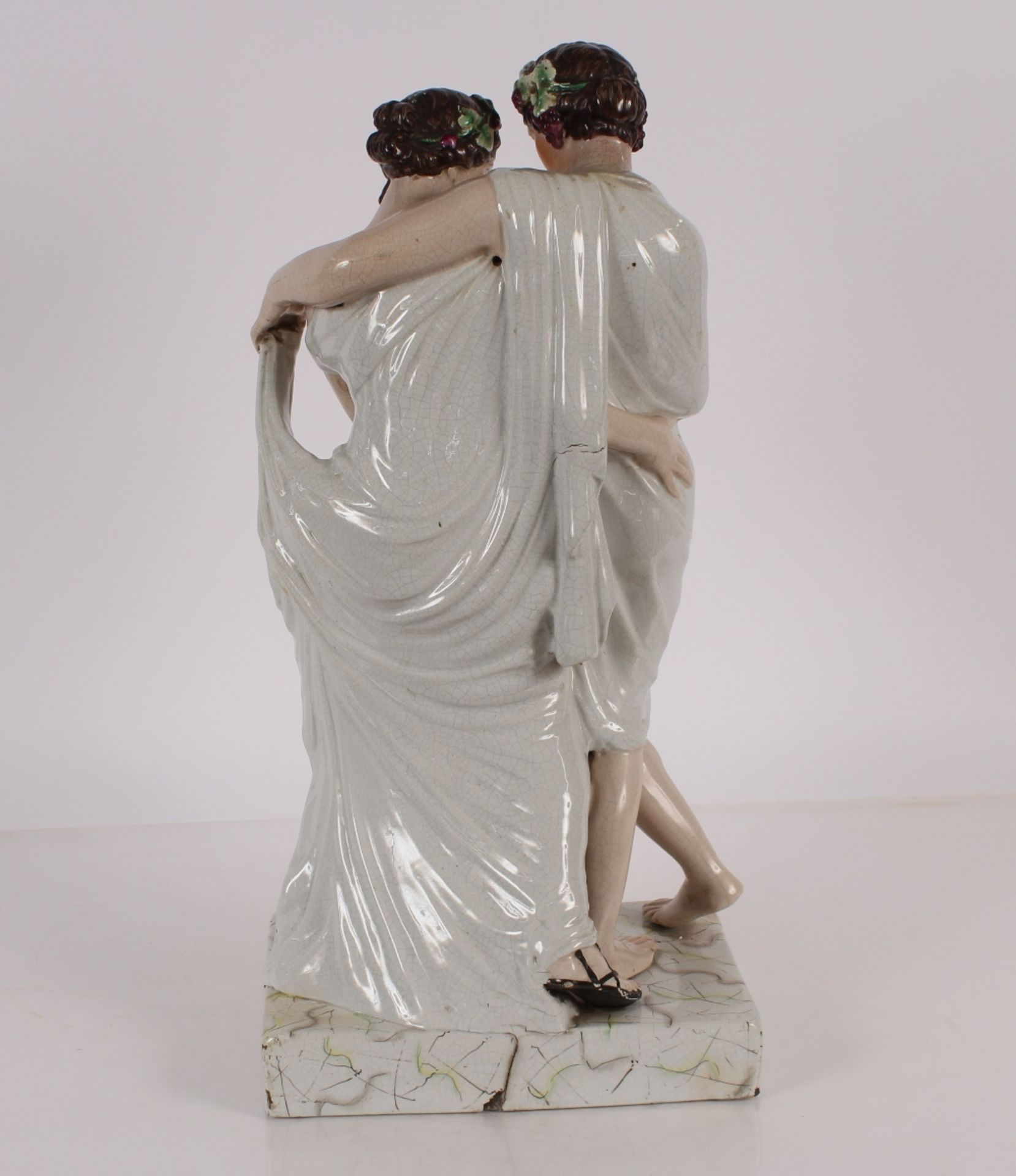 A large Staffordshire figure depicting a Bacchanalian couple, on plinth base, 64cm high - Image 3 of 4
