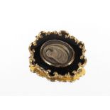 A Victorian metal and black enamel mourning brooch