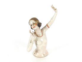 An Art Deco risqué porcelain pin doll, 18cm high