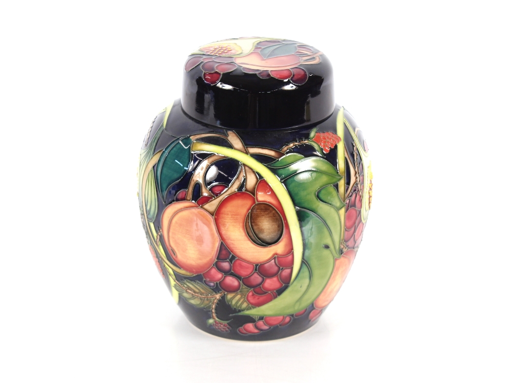 A Moorcroft fruit decorated jar and cover, 20cm high