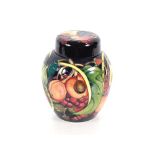 A Moorcroft fruit decorated jar and cover, 20cm high