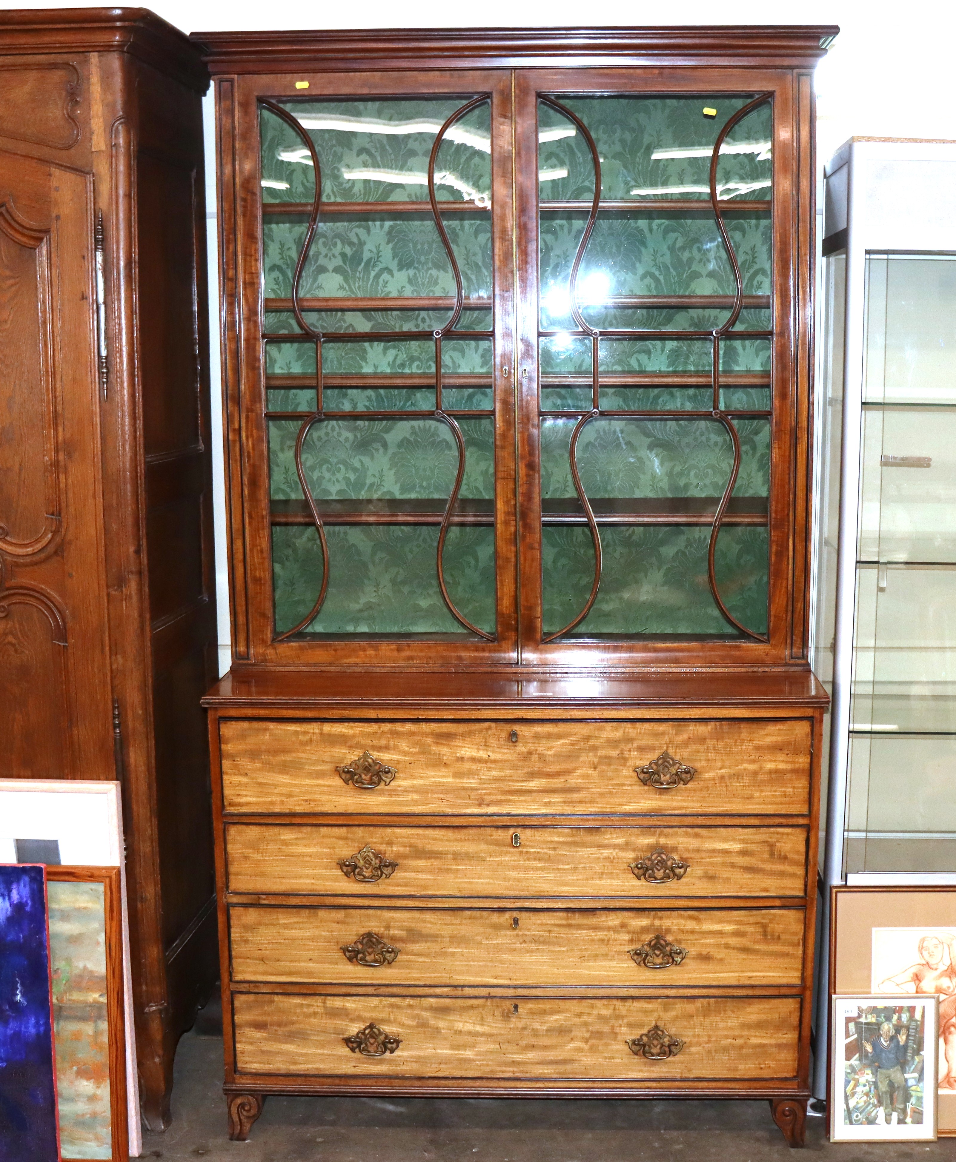 An early 19th Century mahogany secretaire bookcase, the upper adjustable shelves enclosed by a