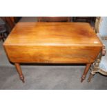 A Victorian mahogany drop leaf supper table,  the rounded drop leaves raised on turned tapering