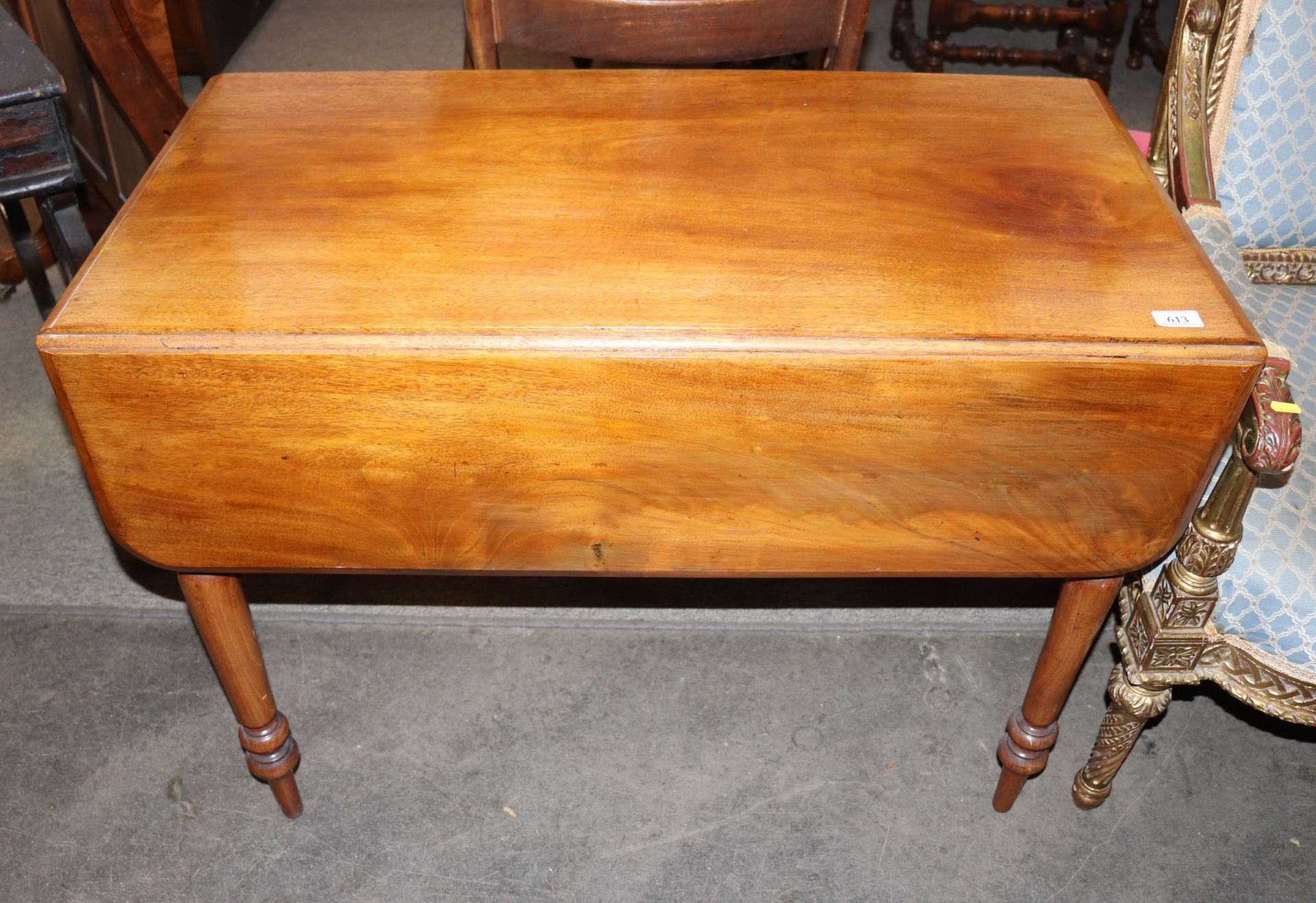 A Victorian mahogany drop leaf supper table,  the rounded drop leaves raised on turned tapering
