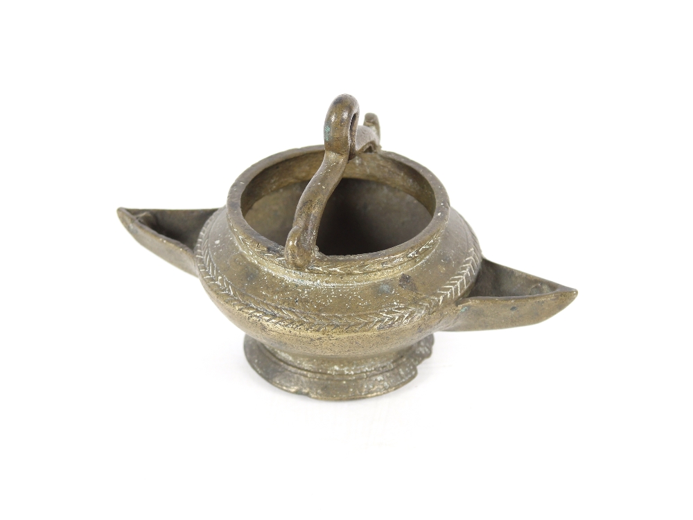 A small Asian bronze double spouted hanging lamp, having chevron banded decoration, 12cm