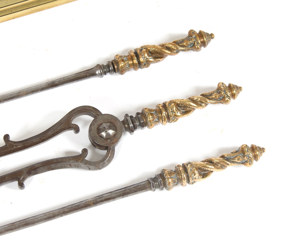 A Victorian brass fender, 139cm wide; a set of three steel and brass fire implements; a pair of - Image 2 of 4