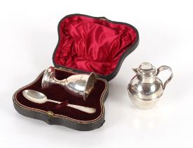 A cased silver egg cup, Birmingham 1910; an associated silver spoon, Sheffield 1907; and a miniature