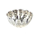 A late Victorian silver sugar bowl, the fluted form with raised floral and fruit decoration,