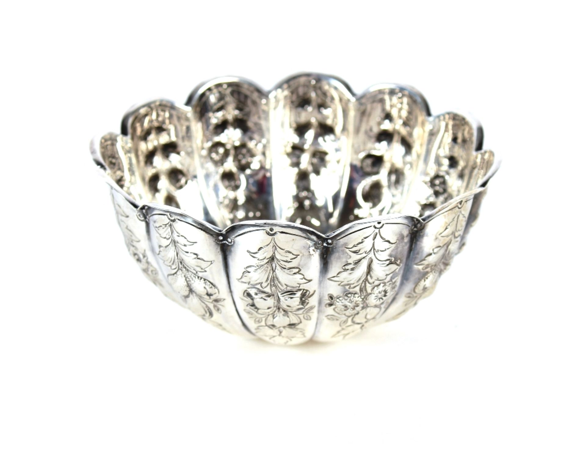 A late Victorian silver sugar bowl, the fluted form with raised floral and fruit decoration,