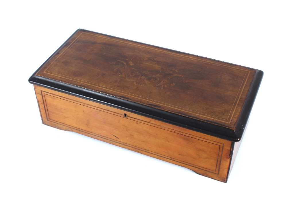 A Swiss rosewood and inlaid cased music box, plating eight airs, 49cm