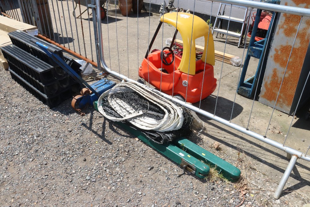 A pair of tennis posts and net and a line marker