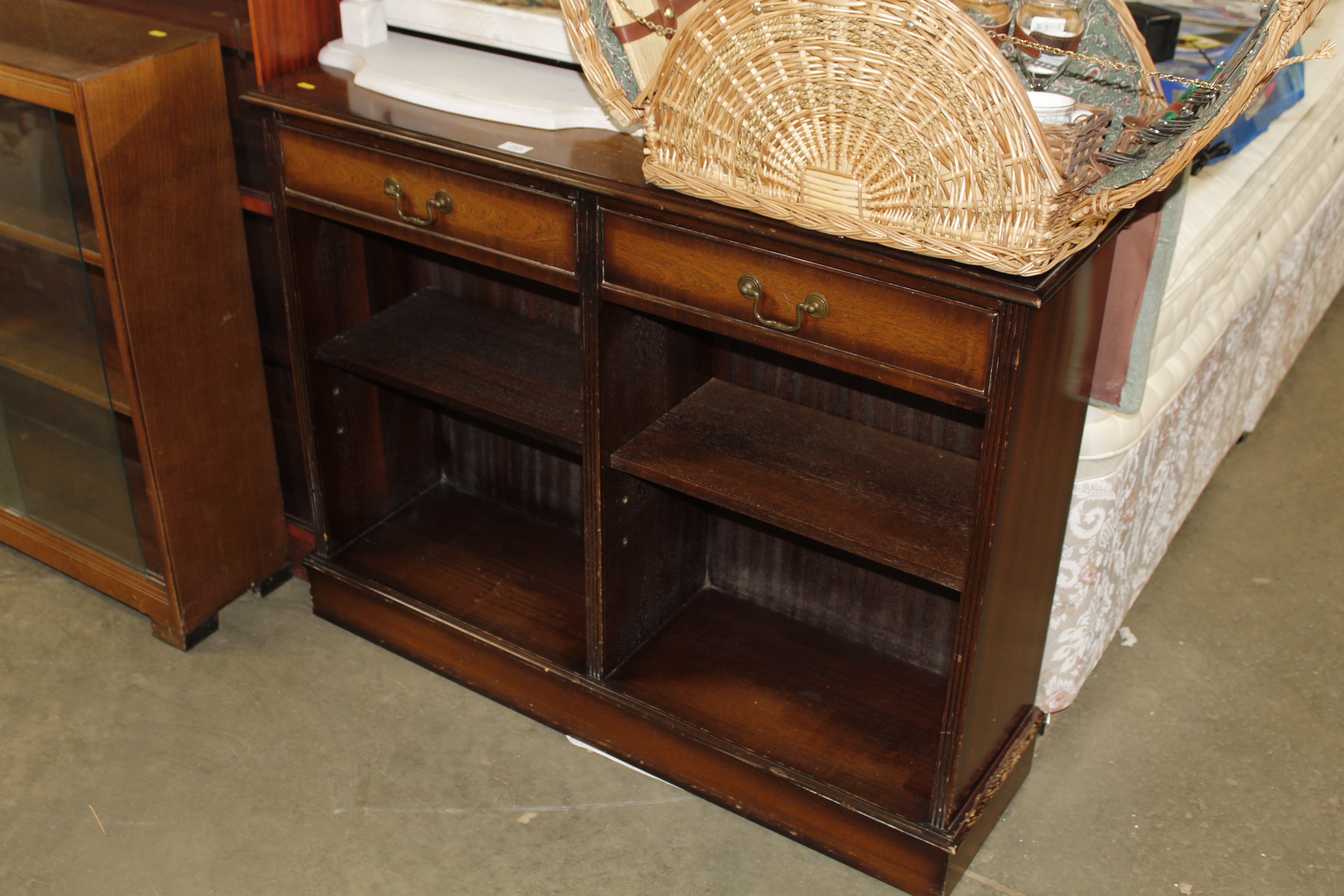 A reproduction mahogany bookcase fitted two drawer