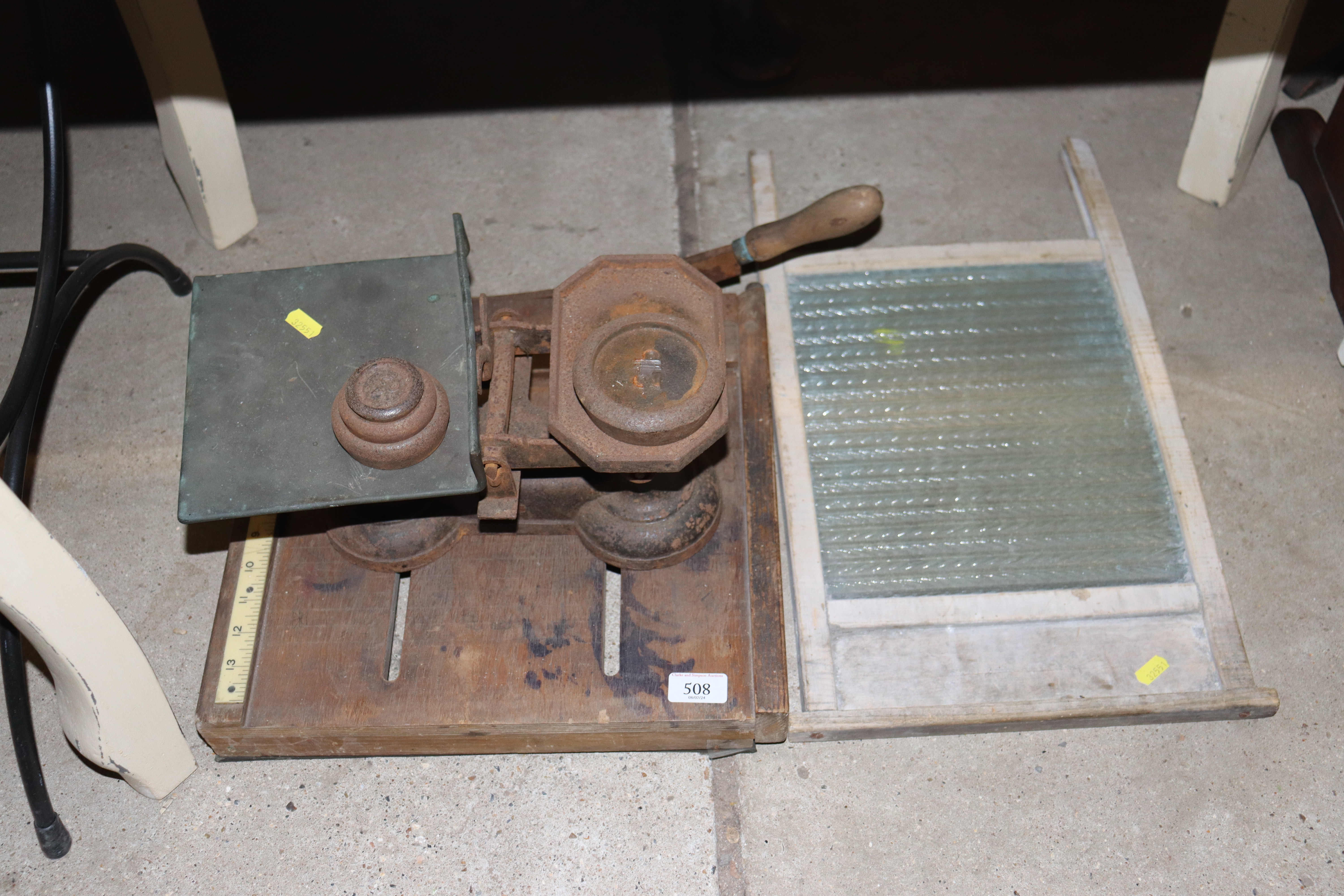 A vintage guillotine; a set of cast iron scales an