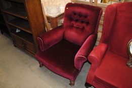 A late Victorian easy chair upholstered in red Dra