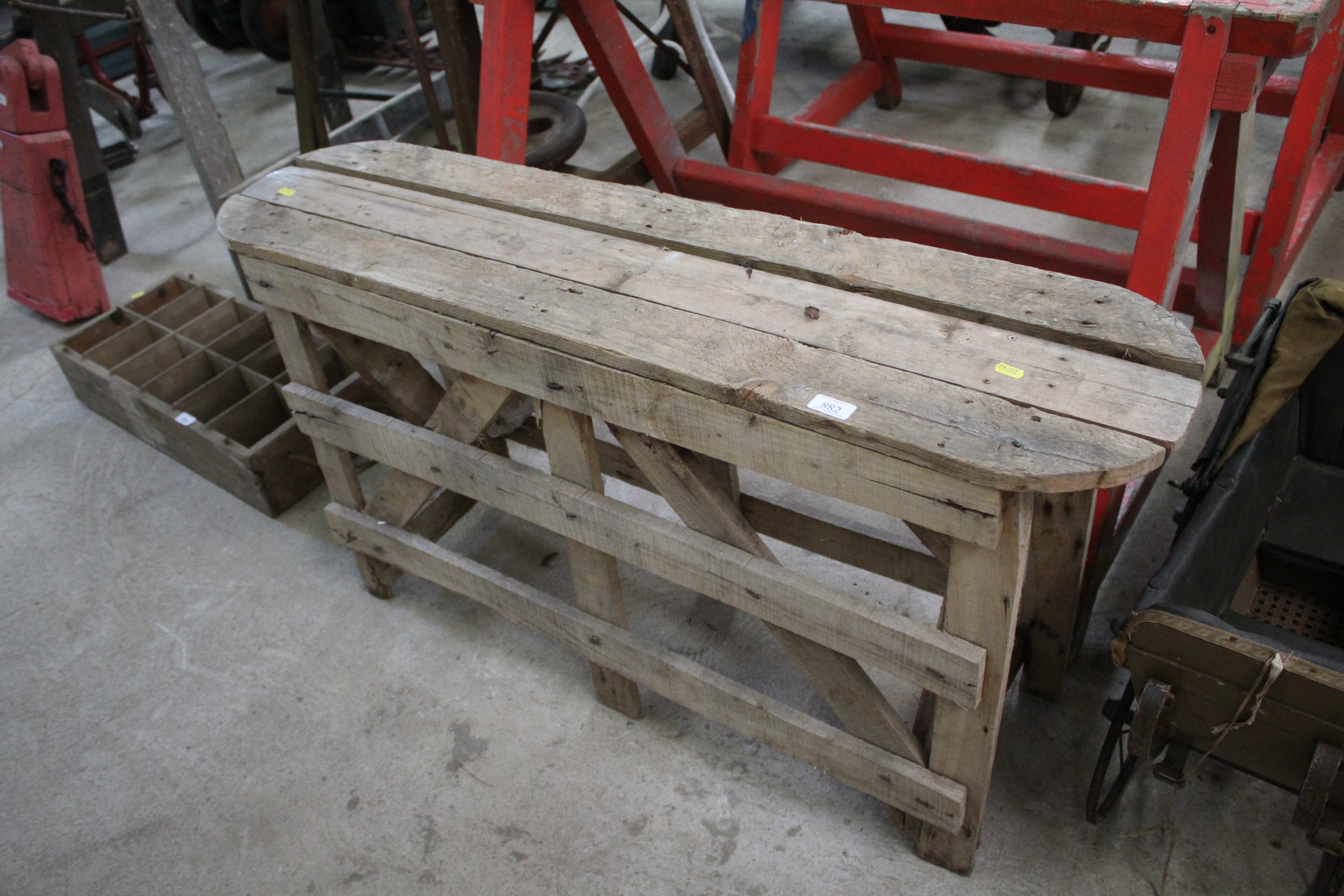 A wooden slatted oval bench