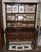 An oak Jacobean style dresser, having open plate rack of two drawers with geometric moulded