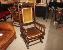 A late Victorian stained beech wood framed, sprung Boston type rocking chair