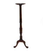 A 19th Century mahogany torchere stand, the circular top raised on a fluted baluster column with