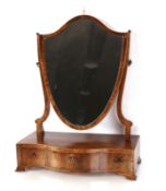 A 19th Century mahogany and rosewood cross banded serpentine swing toilet mirror, the shield