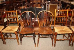 A set of four elm rush seated spindle back dining chairs and a pair of elm seated stick and wheel