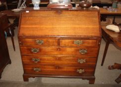 A Georgian oak bureau, the mahogany cross banded fall front opening to reveal an interior