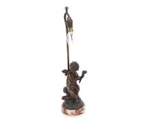 A bronzed table lamp in the form of a cherub on marble plinth