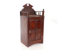 A small Edwardian carved mahogany side cabinet, with raised back, the interior drawers and shelves