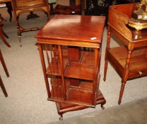 An early 20th Century mahogany revolving bookcase, having spindle columns, and raised on a square