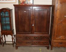An 18th Century antique oak press cupboard, the upper section fitted shelves with two short and