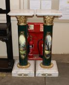 A pair of Classical style marble topped columns with gilded capitals and decoration of landscapes