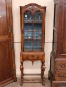 A 19th Century walnut Queen Anne style single door display cabinet fitted drawer to base, raised