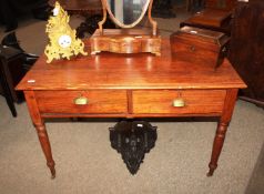 An Edwardian pitch pine school desk, fitted two drawers above turned tapering supports terminating