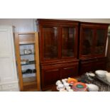 A reproduction mahogany display cabinet raised on