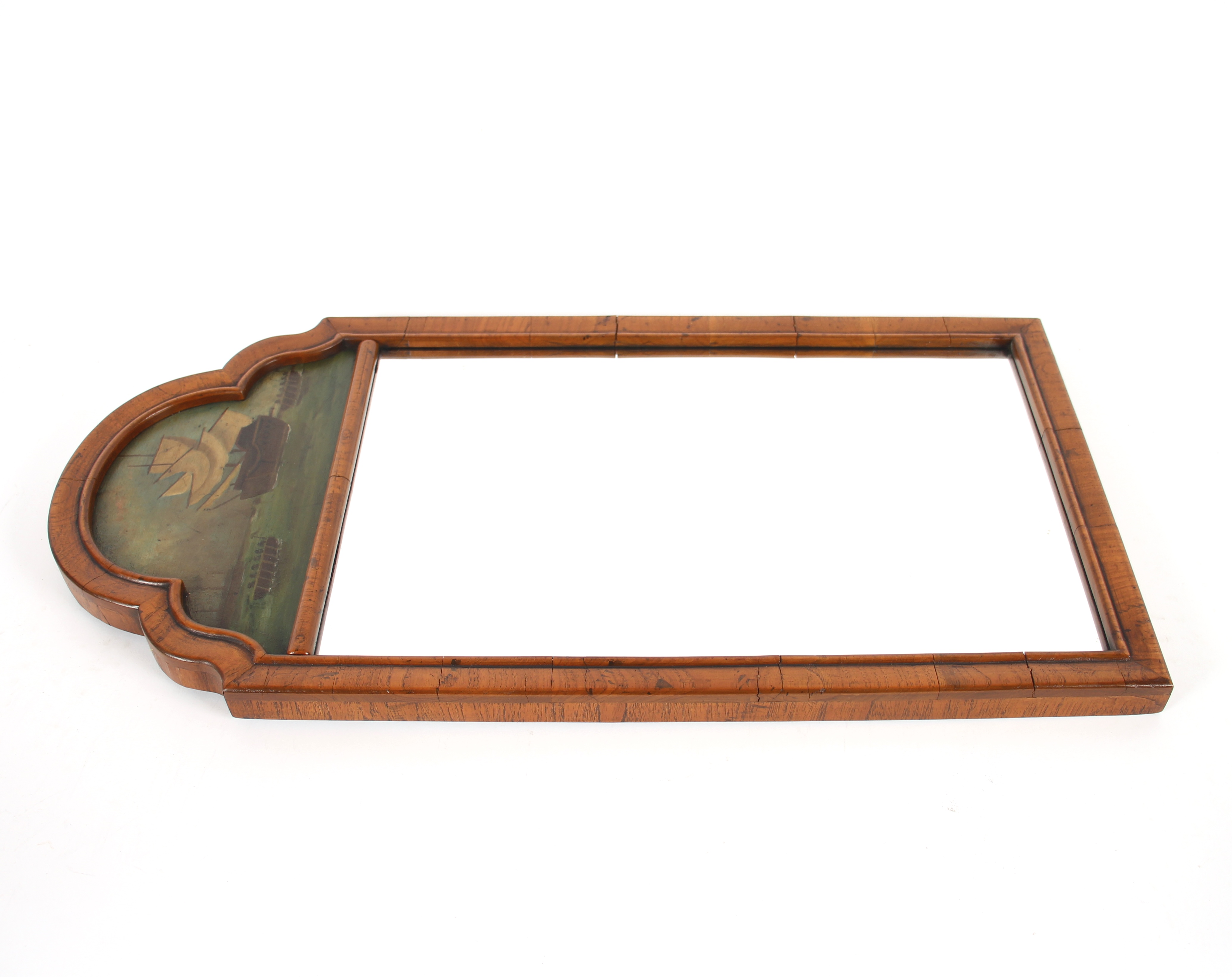 An 18th Century style walnut wall mirror, surmounted by an arched painted panel  depicting marine