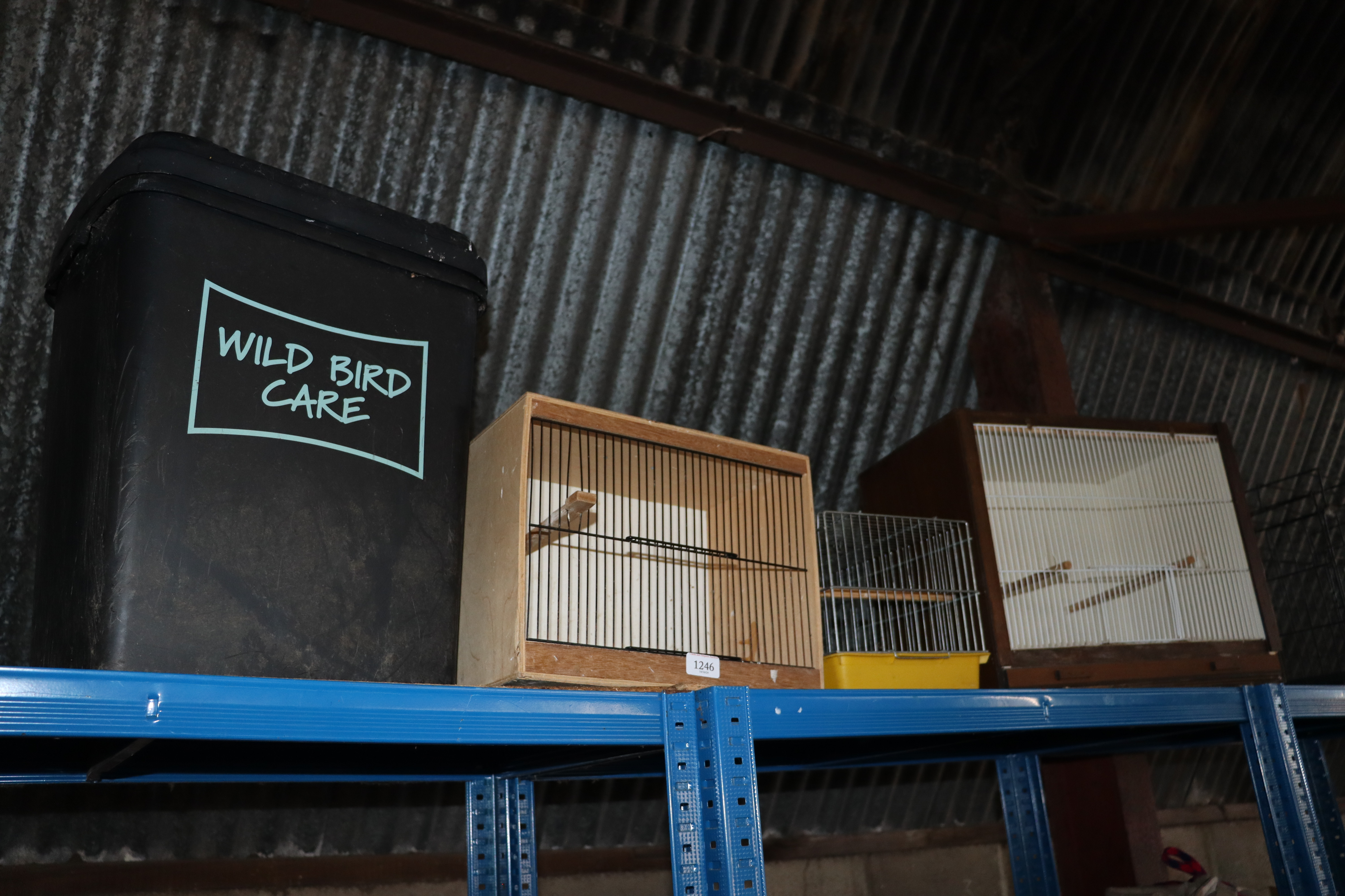 Three bird cages and a wild bird care bin