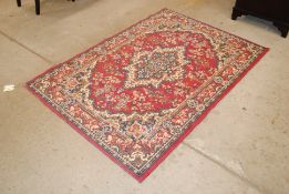 A small Eastern pattern red ground rug
