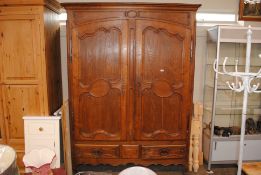 A large oak French armoire, with interior shelf an