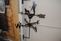 An iron weather vane decorated with a huntsman and dog