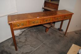 A walnut and cross banded five drawer hall table,