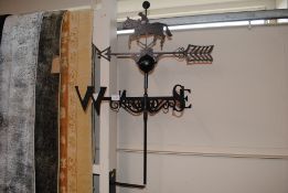 An iron weather vane with horse and jockey decorat