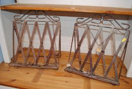 A pair of decorative painted metal bookstands