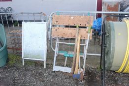 A builders folding workmate, a pick axe, axe and s